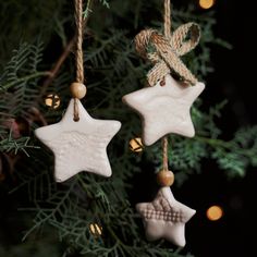 three ceramic stars hanging from a christmas tree