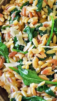 spinach and rice salad in a wooden bowl