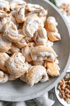 a plate full of cinnamon rolls and nuts