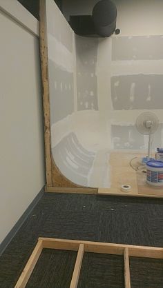 an unfinished room with the walls being painted