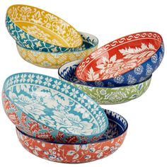 four colorful bowls are stacked on top of each other