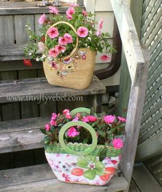 two baskets with flowers are sitting on the steps in front of a house, one is holding a flower pot and the other has a purse