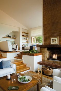 a living room filled with furniture and a fire place in the middle of a room