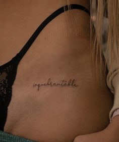 a woman with a tattoo on her stomach that says, opphantaale in cursive writing