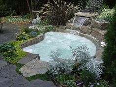 an outdoor hot tub in the middle of a garden