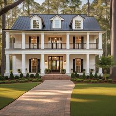 a large white house with black shutters on the front and side windows, surrounded by trees