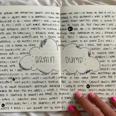 a woman's hand is holding an open notebook with writing on it and the words brain