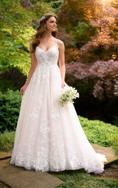 a woman in a wedding dress is standing outside