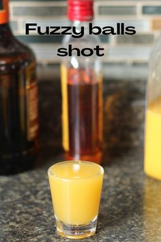 a shot glass filled with liquid sitting on top of a counter