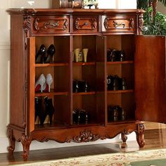 an ornate wooden cabinet with shoes on it