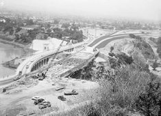 an old black and white photo of a bridge under construction