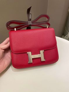 Hermes Constance 18Rouge Casaque Epsom PHWSize 18 x 14 x 5cmQ Square Stamp9-9.5/10 Excellent (minimal faint leather scratches and underflap hardware signs otherwise excellent)Includes dust bagPrice was 12,200 sgdPrice now 11,700 sgd 8880 usd CN5842-04 Hermes Bags Constance, Hermes Constance, Dior Shoes, Louis Vuitton Shoes, Vuitton Bag, Exclusive Bag, Beautiful Packaging, New Bag, Fashion Statement