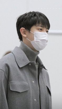 a man wearing a face mask and coat