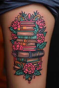 a woman's thigh with books and flowers on it