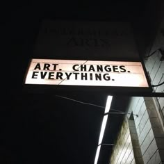 a black and white photo of a street sign that says art changes everything on it