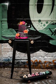 a table that has some cupcakes on it and a skateboard in front of it