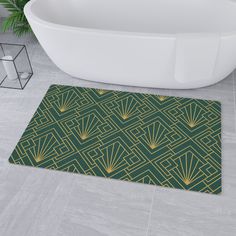 a bath tub sitting next to a green rug