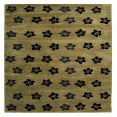 a beige rug with black flowers on it