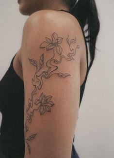 a woman with a flower tattoo on her arm