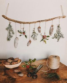 a wooden table topped with pine cones and other christmas decorations on it's side