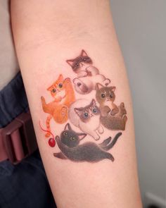 a woman's arm with an image of cats on it