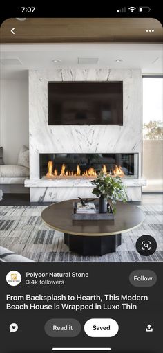 a living room with a fireplace and television above it