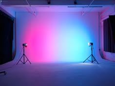 two light stands in front of a pink and blue backdrop