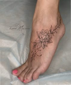 a woman's foot with a flower tattoo on it