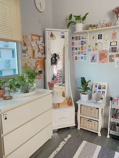 a room filled with lots of furniture and plants on top of it's shelves