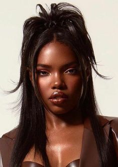 a close up of a woman with long hair wearing a brown dress and piercings