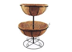 three tiered tray with coconuts on the bottom and metal stand for serving food