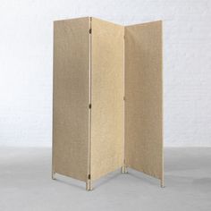 a room divider made out of cardboard with metal legs and two panels on each side