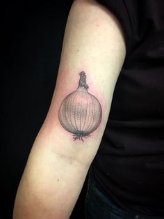 an onion tattoo on the arm