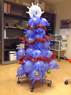 a christmas tree made out of balloons in an office