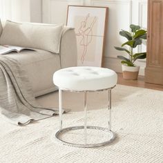 a white ottoman sitting on top of a rug in a living room