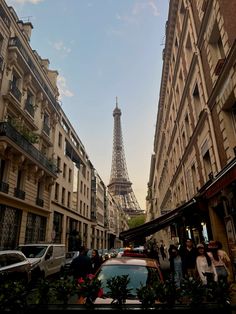 the eiffel tower is in the distance behind some buildings