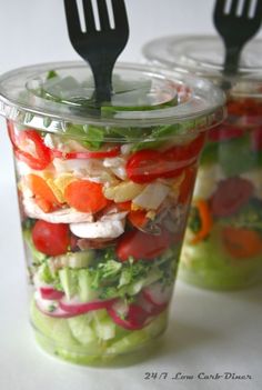 an image of a salad in a plastic container with a fork stuck into the jar