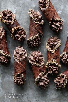 chocolate pastry with frosting and sprinkles arranged on a gray table top