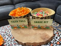 two bowls filled with snacks sitting on top of a table