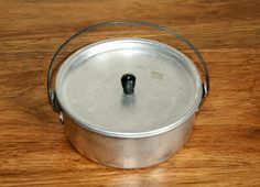 a metal pan sitting on top of a wooden table