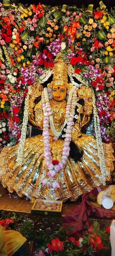 an idol is surrounded by flowers and garlands