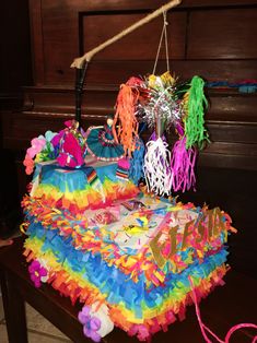 a piano with colorful decorations hanging from it's strings and on top of it