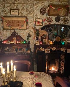 a table with candles on it in front of a fireplace