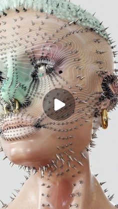 a woman's head is covered in spikes and other metal parts that are attached to her face