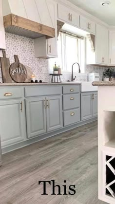 a kitchen with gray cabinets and white counter tops is featured in this post - it - yourself photo