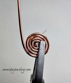 a close up of a metal object with a wire attached to the back of it