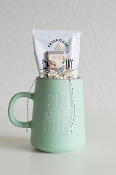 a coffee mug filled with assorted items sitting on top of a white countertop