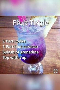 a glass filled with purple liquid and topped with a slice of pizza on top of it