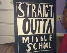 a black and white sign that says straight outa middle school in front of a purple wall