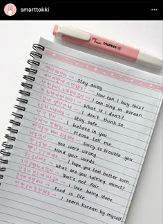 a notepad with writing on it next to a pink pen and paper clipping